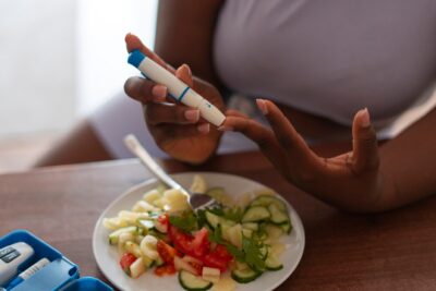 high angle woman checking glucose levels